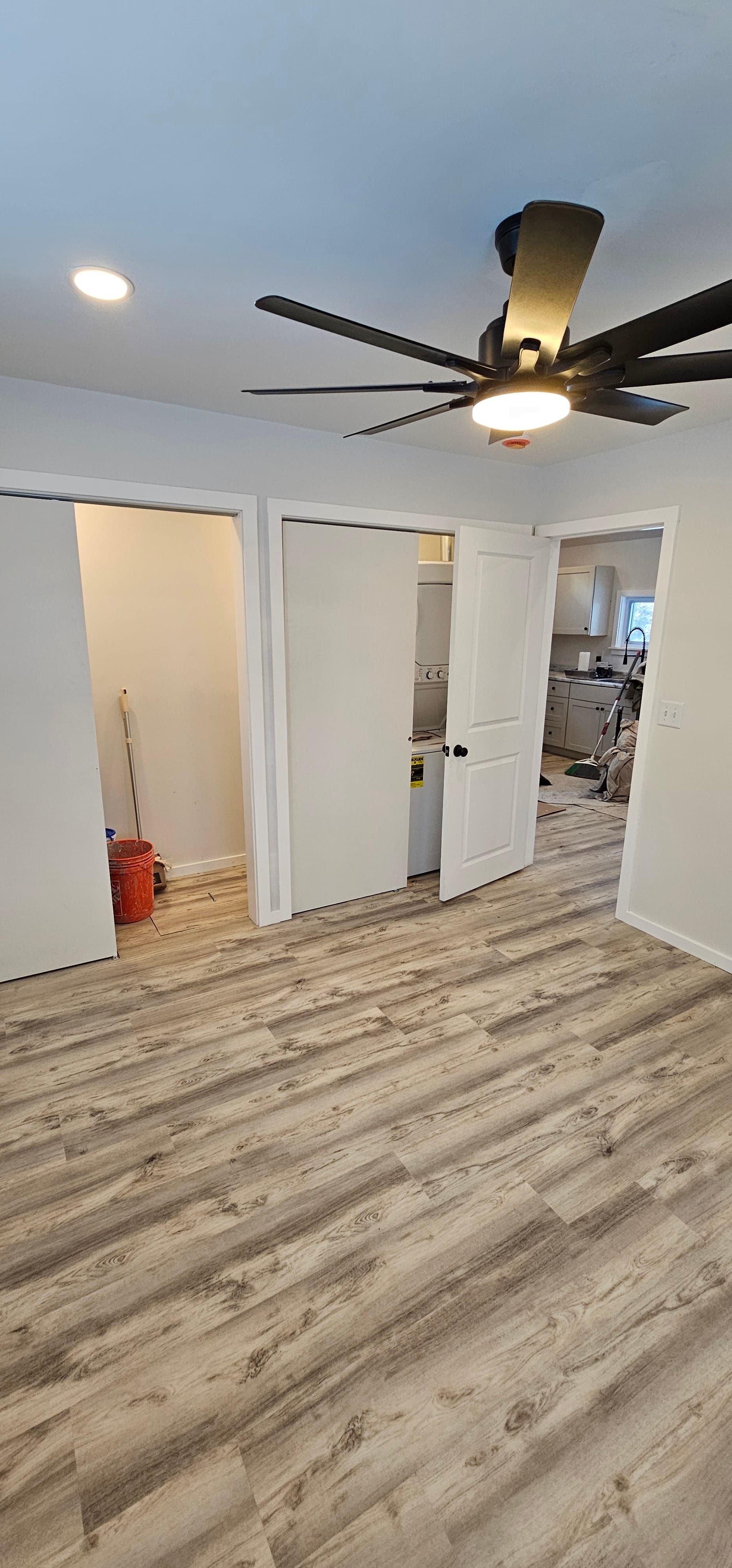 ADU bedroom with ceiling fan and closets